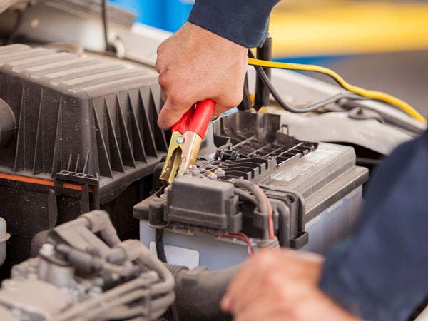 Close Up of Tow Truck Operator Jump Starting A Battery San Antonio