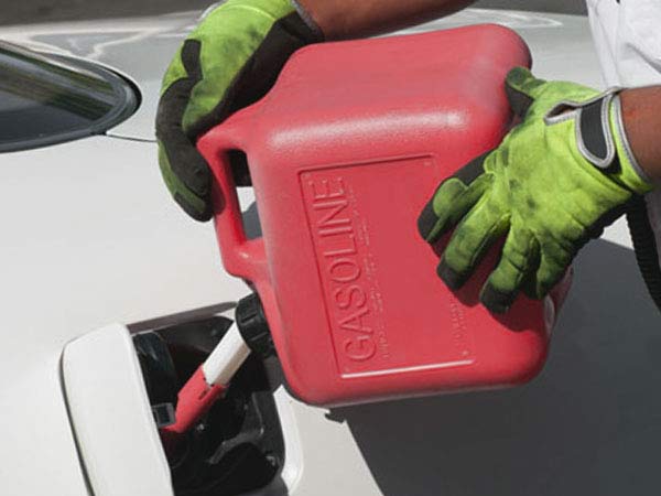 Tow Truck Operator Pouring Gas Into Empty Car Tank San Antonio